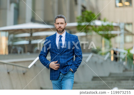 Ambitious businessman outdoor. Business CEO. Man of success. Successful business. Successful business man in American street. Man lawyer. Businessman walking in city. Businessman in suit Ambitious businessman outdoor. Business CEO. Man of success. Successful business. Successful business man in American street. Man lawyer. Businessman walking in city. Businessman in suit 119973255