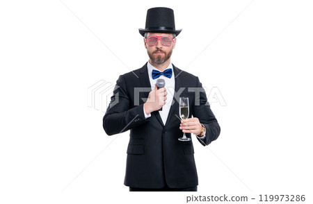 showman man entertainer cheering with microphone. man showman wear tuxedo cheering in studio 119973286