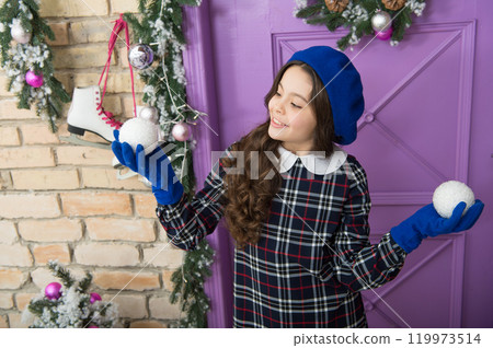 nice day. small french girl. trendy kid decorative xmas ball. home and christmas tree decor. happy new year. smiling parisian child in beret and gloves. winter holiday activity. christmas shopping 119973514