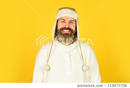 Waiting for warming. Spring is coming. Bearded man wear hat with ear flaps. Furry accessory. Fur garments. Bearded hipster. Winter fashion concept. Warm hat for cold weather. Natural sheep fur Waiting for warming. Spring is coming. Bearded man wear hat with ear flaps. Furry accessory. Fur garments. Bearded hipster. Winter fashion concept. Warm hat for cold weather. Natural sheep fur 119973706