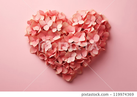 A heart shape made of delicate pink hydrangea petals on a soft pink background A heart shape made of delicate pink hydrangea petals on a soft pink background 119974369