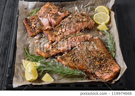 baked salmon fillet on baking tray, top view baked salmon fillet on baking tray, top view 119974666