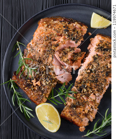 baked salmon fillet with lemon, rosemary on plate 119974671