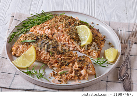 baked salmon fillet with lemon, rosemary on plate baked salmon fillet with lemon, rosemary on plate 119974673
