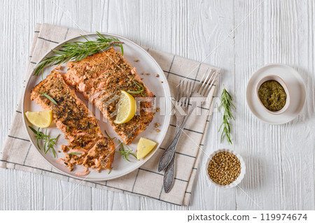 baked salmon fillet with lemon, rosemary on plate baked salmon fillet with lemon, rosemary on plate 119974674