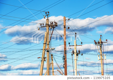 Electrical grid, high tension power lines, part of the electricity distribution system, on a sunny day. Electrical grid, high tension power lines, part of the electricity distribution system, on a sunny day. 119975105