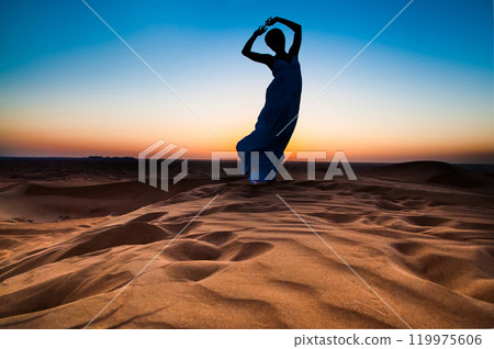 silhouette young woman in sandy desert at sunset silhouette young woman in sandy desert at sunset 119975606