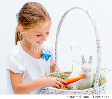 Cute Little girl with a rabbit in a basket Cute Little girl with a rabbit in a basket 119975613