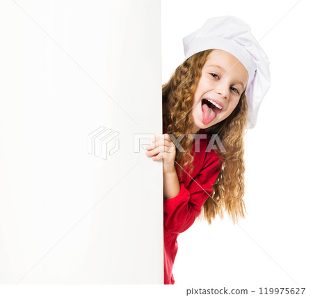 little girl in chef hat with a white board shows tongue 119975627