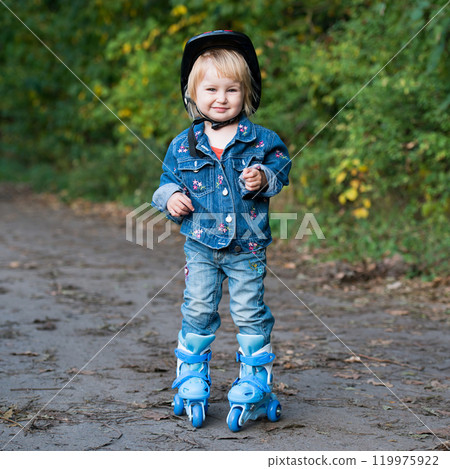 Smiling little girl on roller skates in the park Smiling little girl on roller skates in the park 119975922