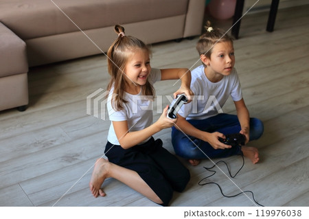 A lively scene of a boy and girl enthusiastically playing video games together at home. they immerse themselves in the gaming experience, highlighting the joy of childhood and the importance of 119976038