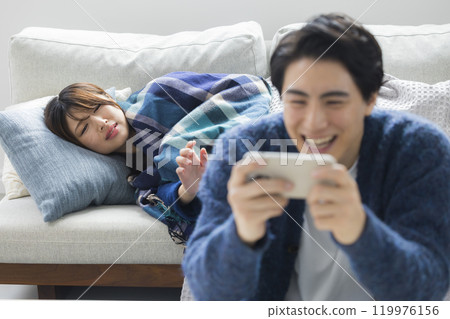 Woman feeling unwell in living room in winter 119976156