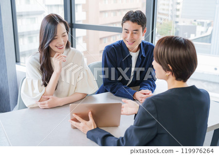 A female real estate salesperson and her customer couple 119976264