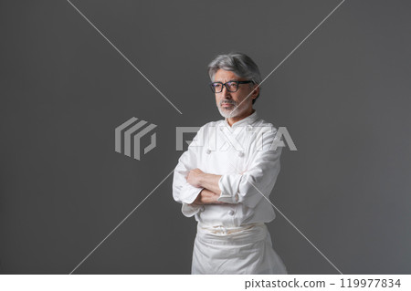 Senior man wearing a chef's coat Senior man wearing a chef's coat 119977834