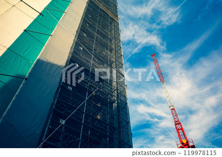 Building under construction and tower crane a-3 Emphasis on warm and cool colors 119978115