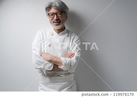 Smiling chef with arms folded Smiling chef with arms folded 119978170