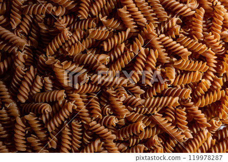 Uncooked Whole Grain Fusilli Pasta Background 119978287
