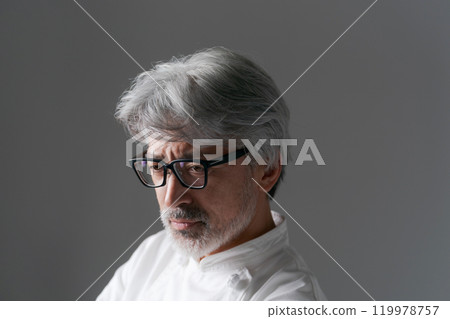 Close-up of a senior man wearing a chef's coat Close-up of a senior man wearing a chef's coat 119978757