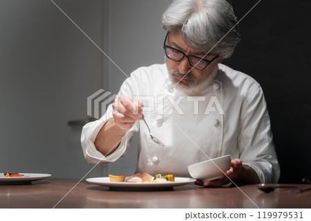 Male chef preparing a dish 119979531