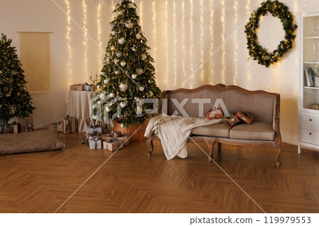A cozy living room with a grey couch and a Christmas tree A cozy living room with a grey couch and a Christmas tree 119979553
