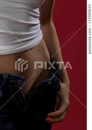 Sexy blonde in unbuttoned jeans and top view 119980634