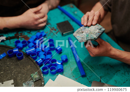 Male worker holding reclaimed tile 119980675