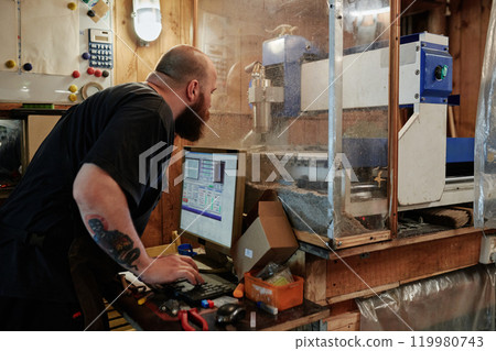 Male engineer operating cutting machine 119980743
