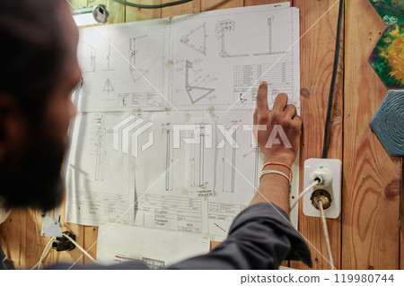 Male engineer checking detail dimensions 119980744