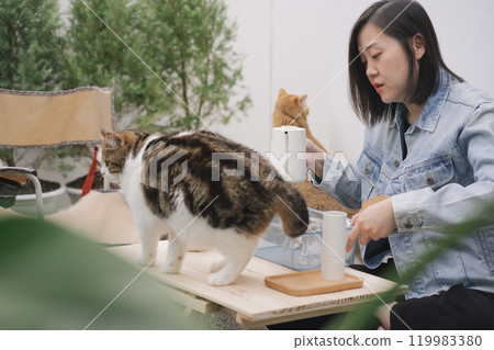 people activity concept with asian woman happy feeling for drip and drink coffee at home with her cat 119983380