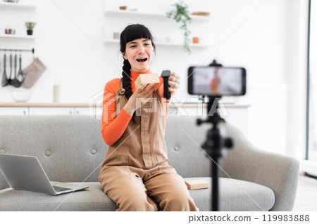 Caucasian female blogger unpacking smart watch for online video Caucasian female blogger unpacking smart watch for online video 119983888