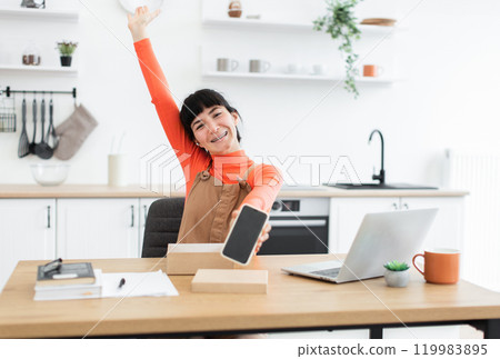 Excited young woman unboxing new smartphone at home Excited young woman unboxing new smartphone at home 119983895