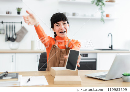 Excited blogger unboxes new smartphone during live streaming session 119983899