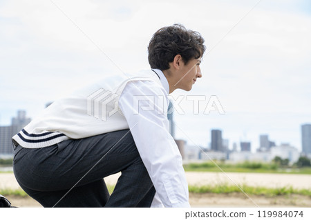 Male student preparing for a crouching start 119984074