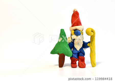 Santa Claus with a Christmas tree and a staff. Santa Claus with a Christmas tree and a staff. 119984418