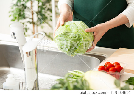 中高級婦女在家裡的廚房拿著高麗菜 119984605