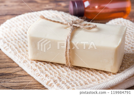 Spa and Wellness concept on wooden background. Soap and massage brush and oil. Spa and Wellness concept on wooden background. Soap and massage brush and oil. 119984791