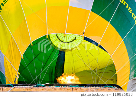 Colorful hot air balloon flying over blue sky with white clouds	 119985033