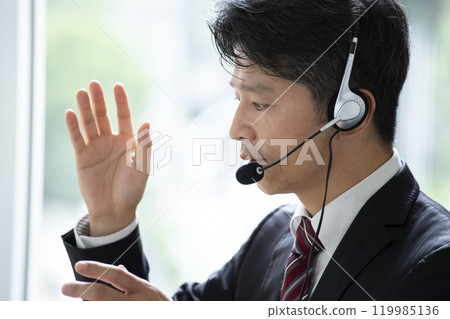 A man wearing a headset at work 119985136