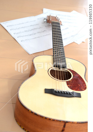 Acoustic guitar, capo, sheet music and music image Acoustic guitar, capo, sheet music and music image 119985330