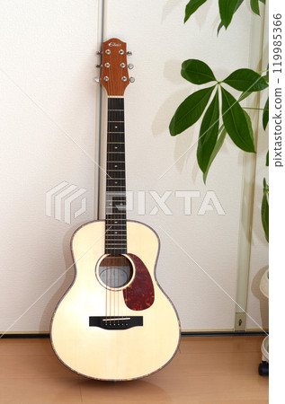 Acoustic guitar leaning against a wall Acoustic guitar leaning against a wall 119985366