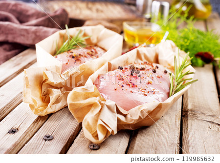 Fresh chicken breast fillet on a wooden table Fresh chicken breast fillet on a wooden table 119985632
