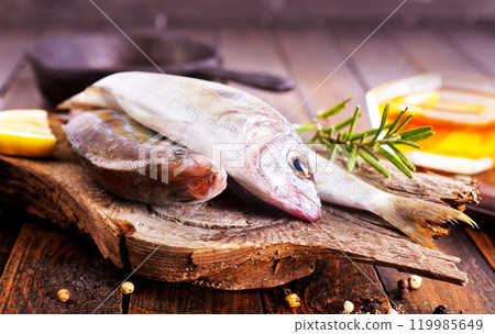 raw fish on wooden board 119985649