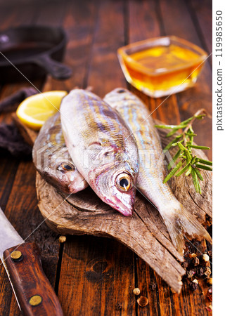 raw fish on wooden board 119985650