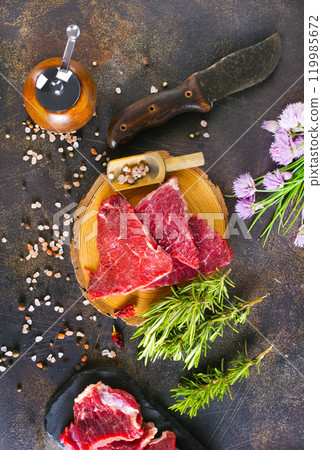 Juicy raw piece of meat on a wooden board 119985672