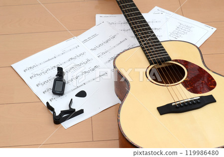 Acoustic guitar, capo, sheet music and music image Acoustic guitar, capo, sheet music and music image 119986480