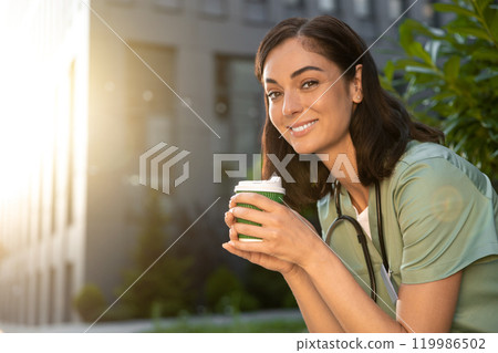 Young female doctor having coffee in the morning after a night shift Young female doctor having coffee in the morning after a night shift 119986502