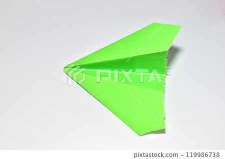 Green paper airplane. Green paper airplane. 119986738