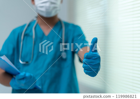 Healthcare Professional Giving Thumbs Up with Protective Gloves and Mask Healthcare Professional Giving Thumbs Up with Protective Gloves and Mask 119986821