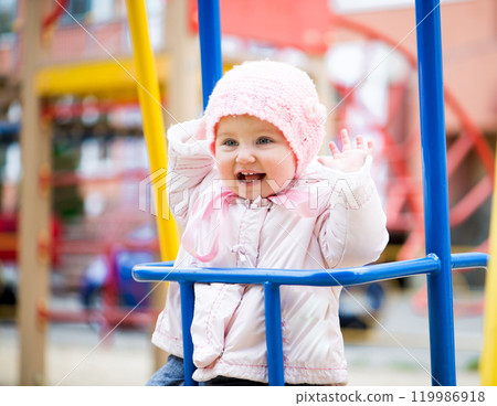 fun little baby swinging at the park fun little baby swinging at the park 119986918