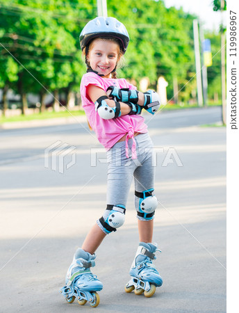 Little girl on roller skates at park 119986967